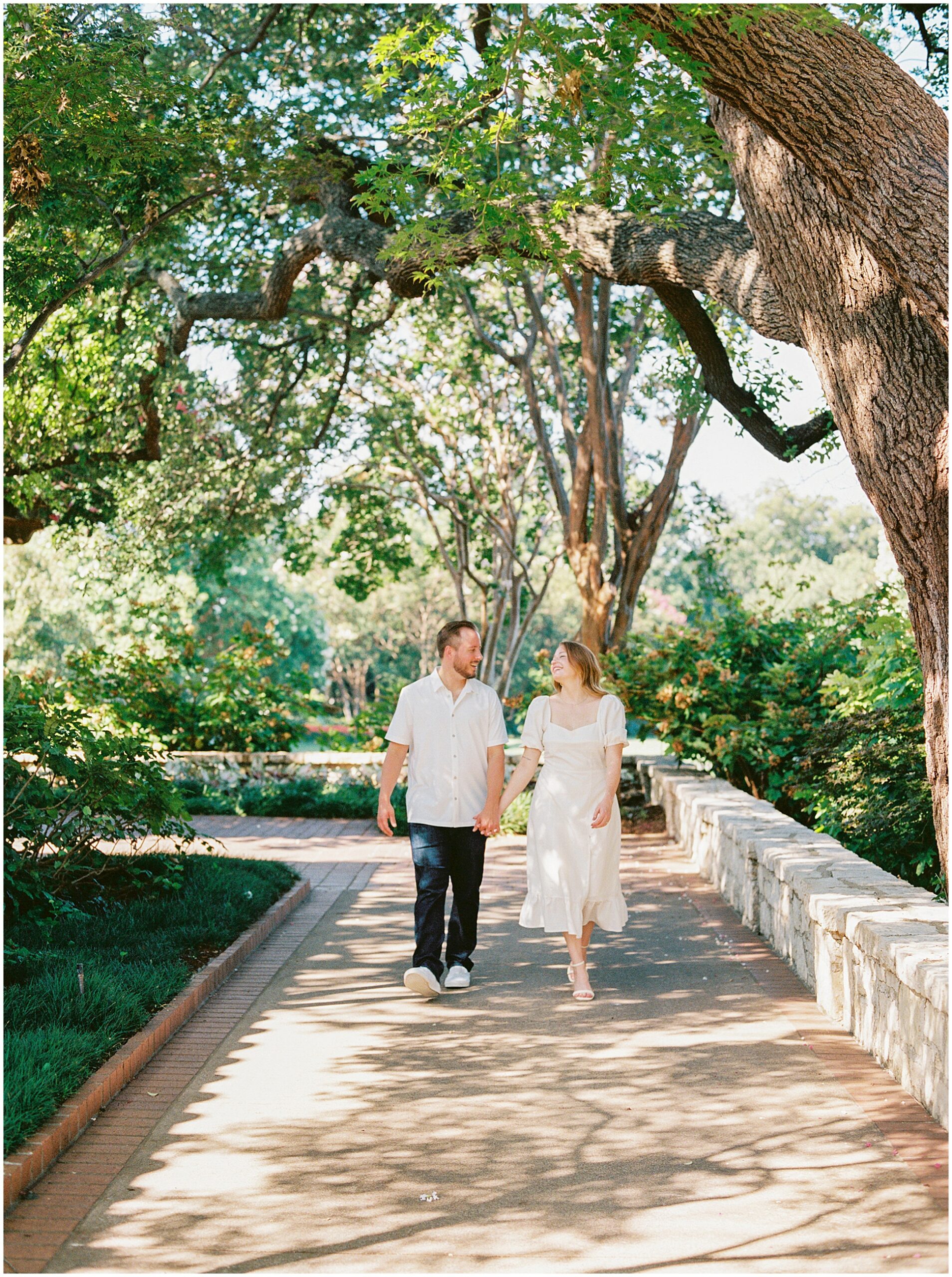 shot of Corey and Summer morning photo of Caitlyn and Corey embracing in the lush greenery of the Dallas Arboretum.