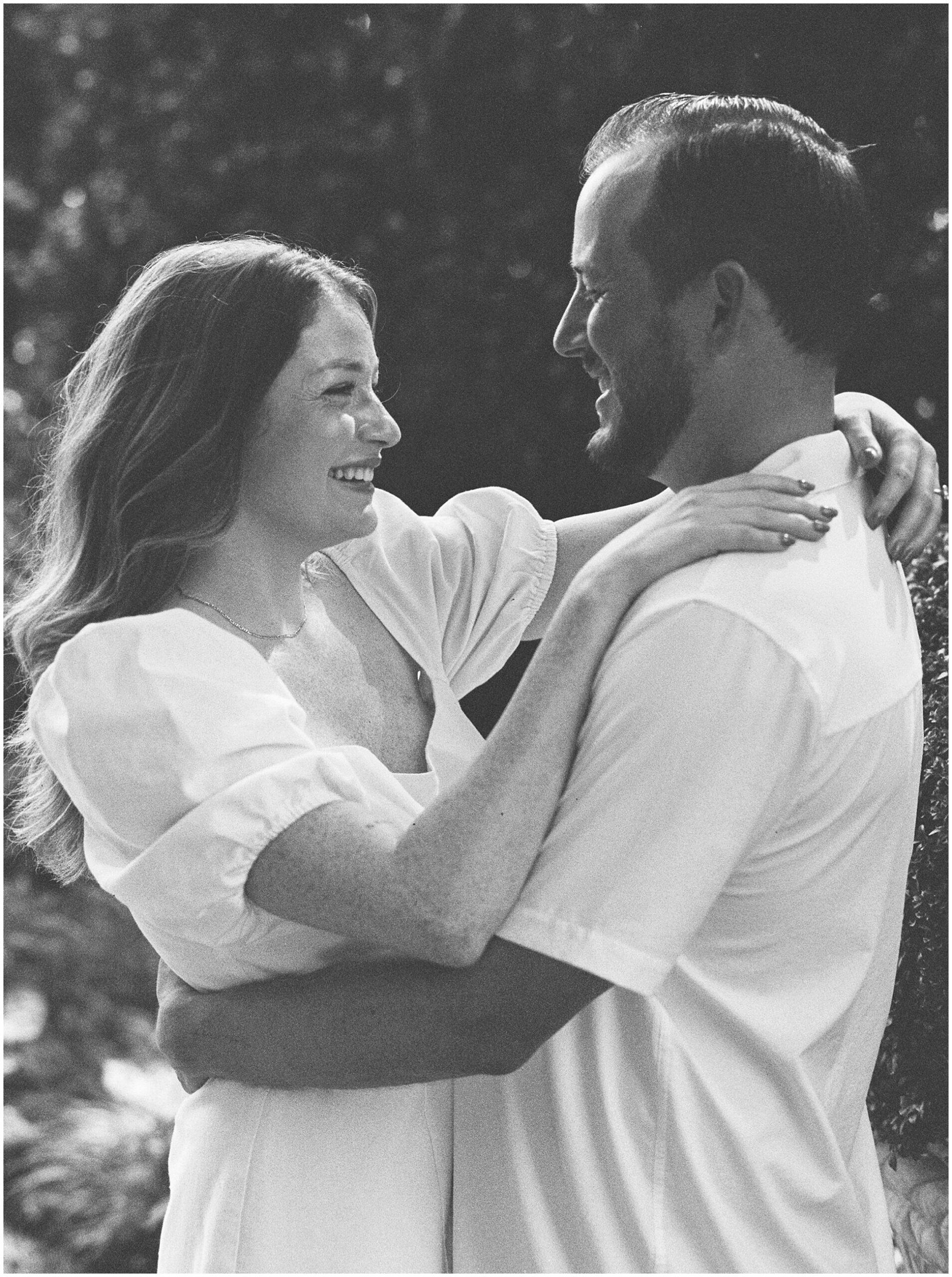 black and white film photo of Caitly and Corey at their engagement session at Dallas Arboretum