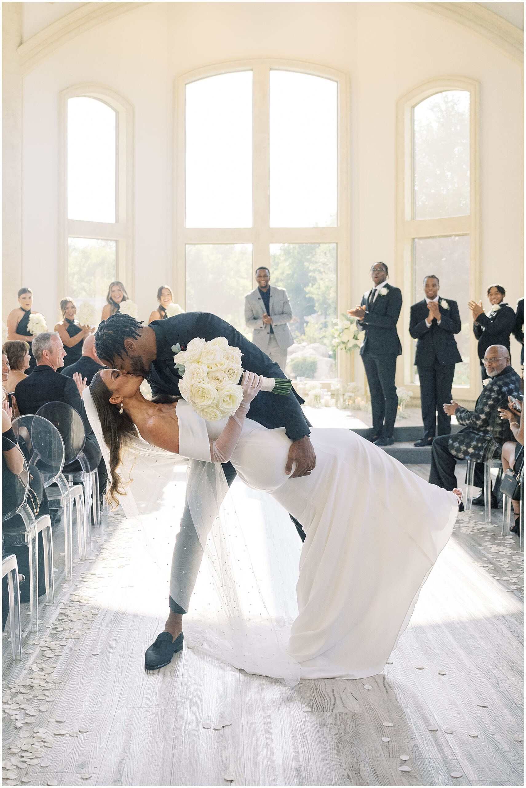 abbi and juwan kiss in middle of aisle at knotting hill