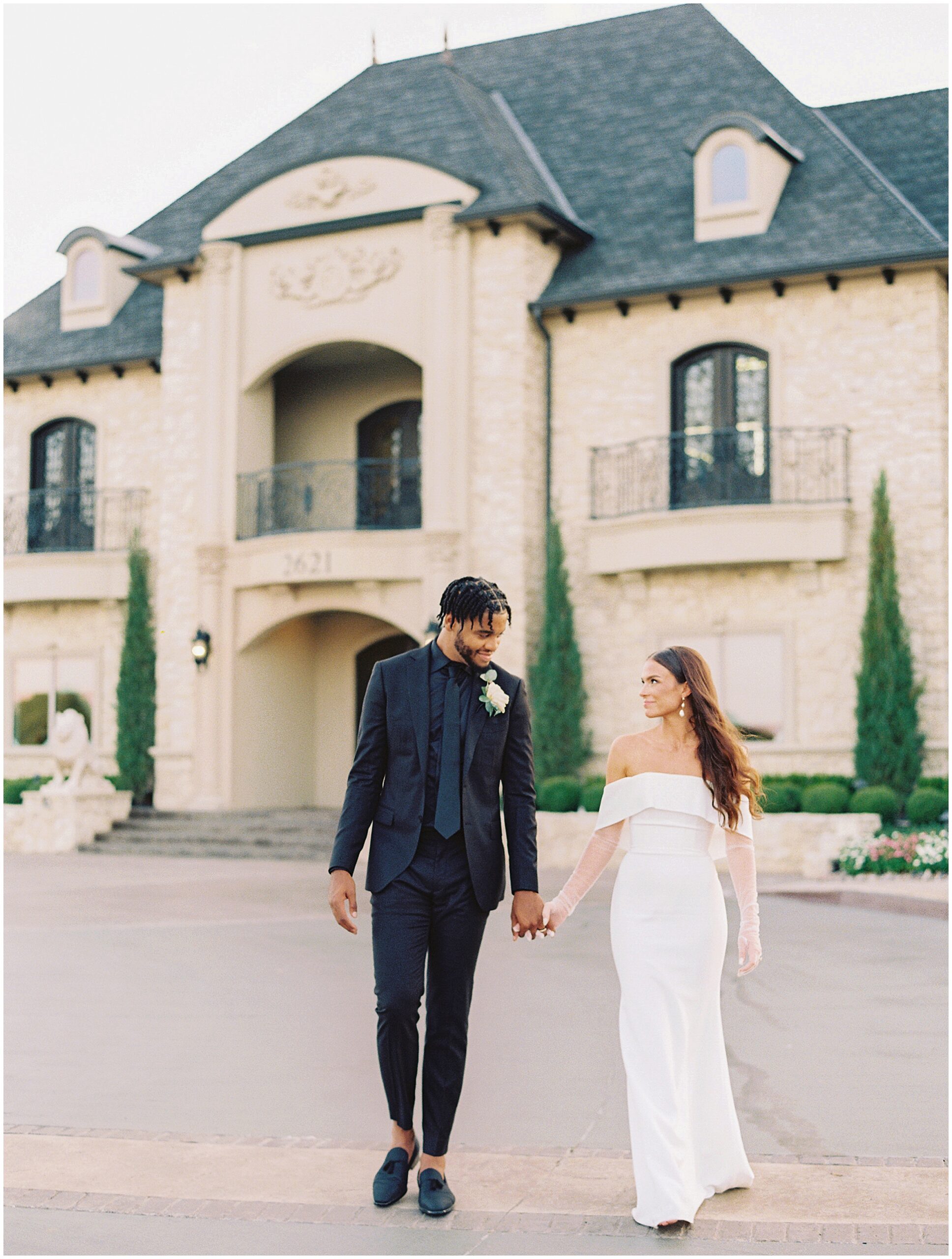 a film photograph of Abbi and Juwan standing in front of the elegant Knotting Hill venue, looking radiant and in love.