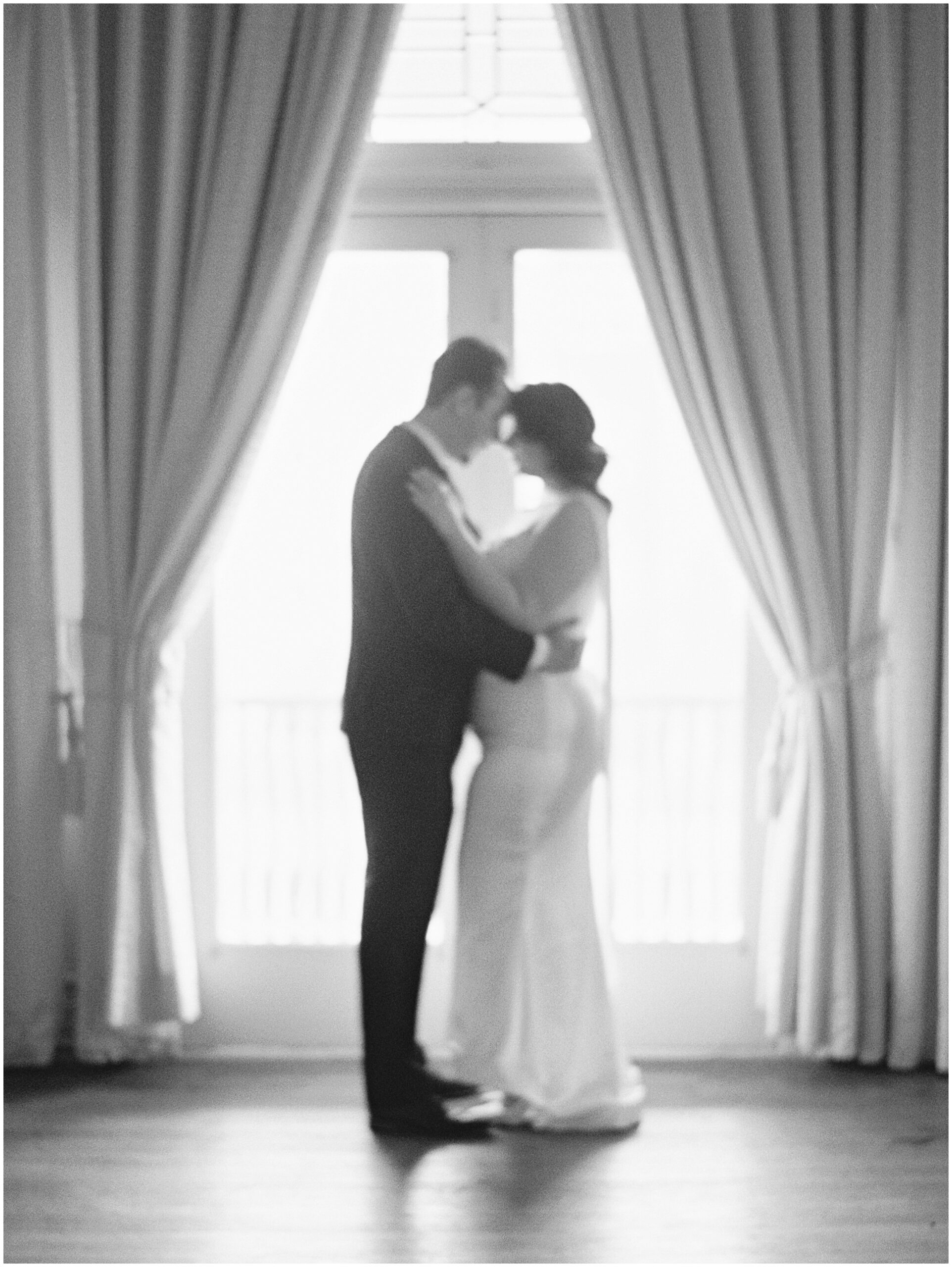 Silhouette of couple in the upstairs window of the Alexander Mansion