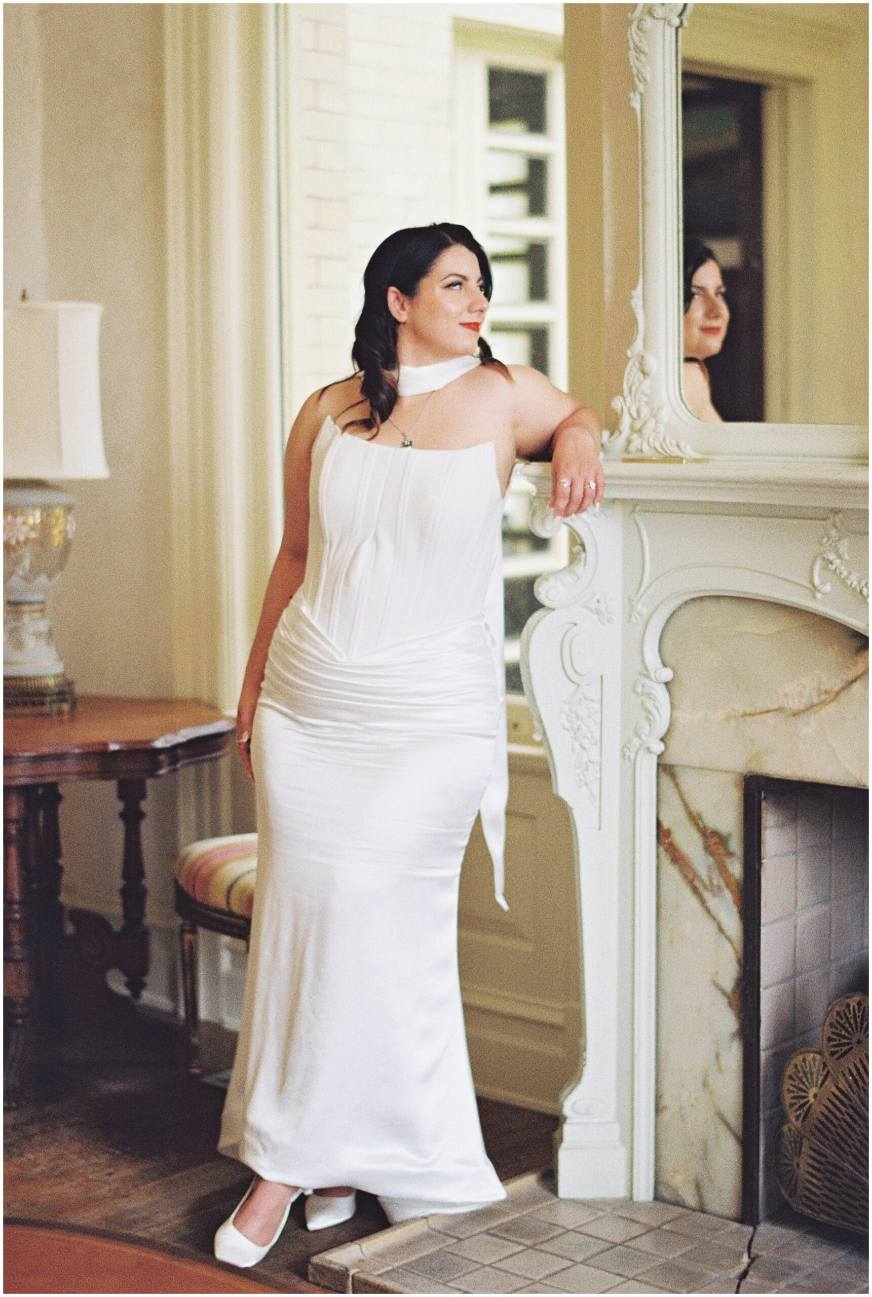 Bride beside the marble fireplace at the Alexander Mansion