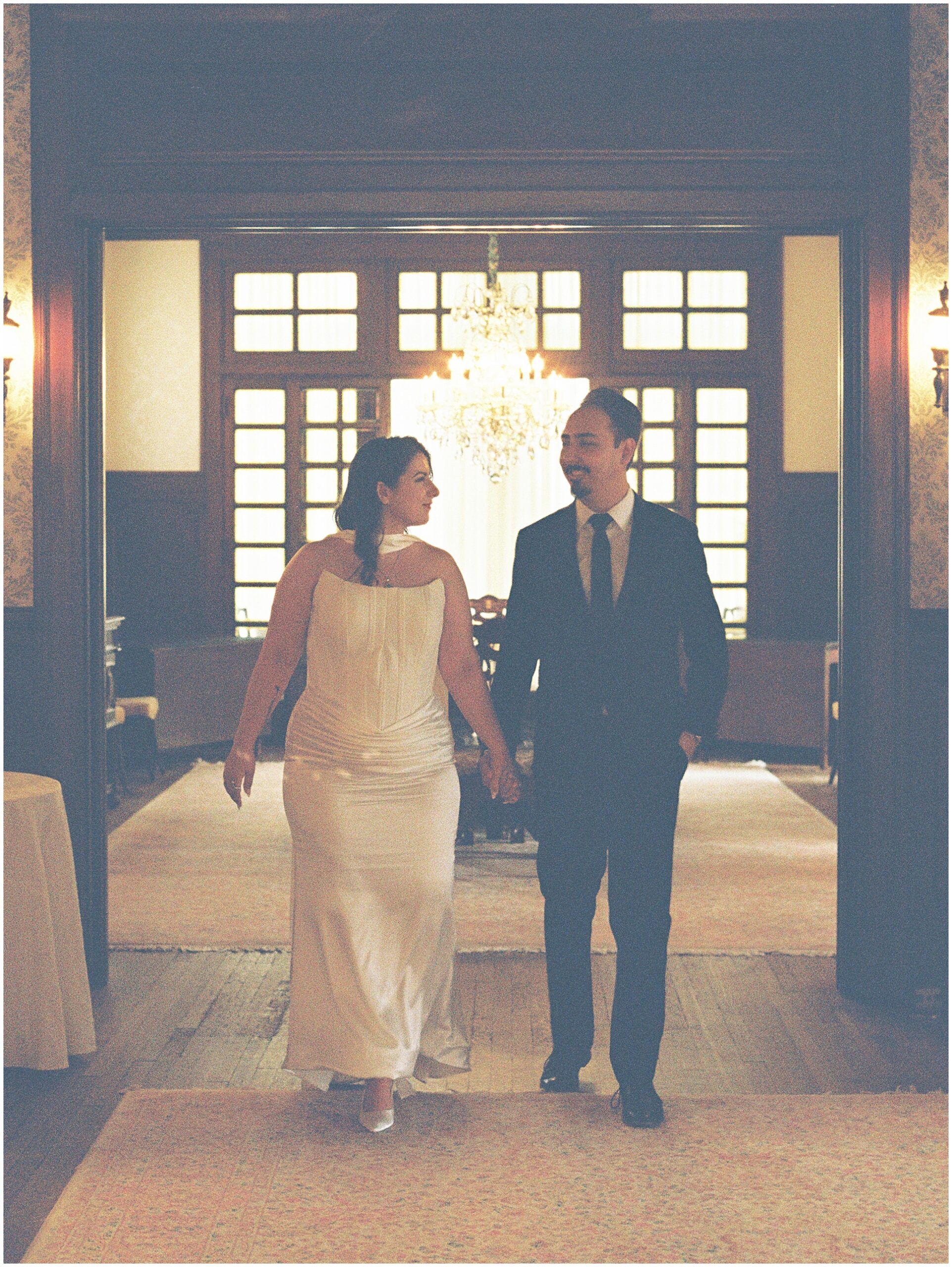 couple walking through halls of alexander mansion