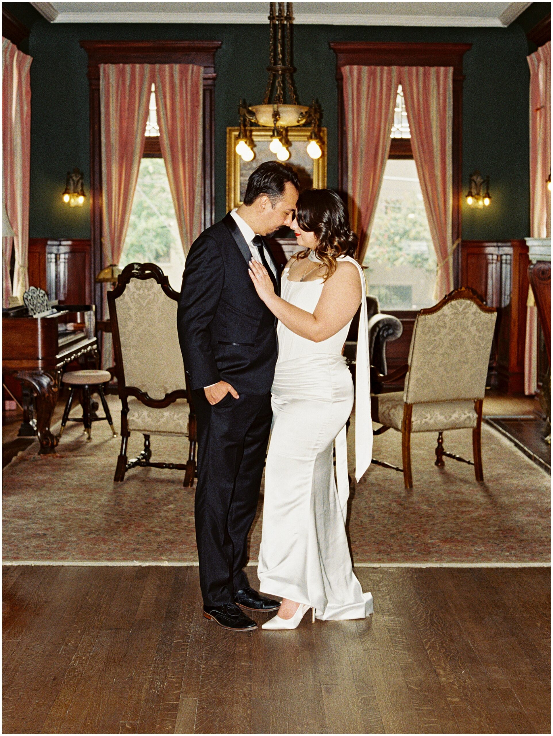 Couple standing in the Alexander Mansion parlor, on film