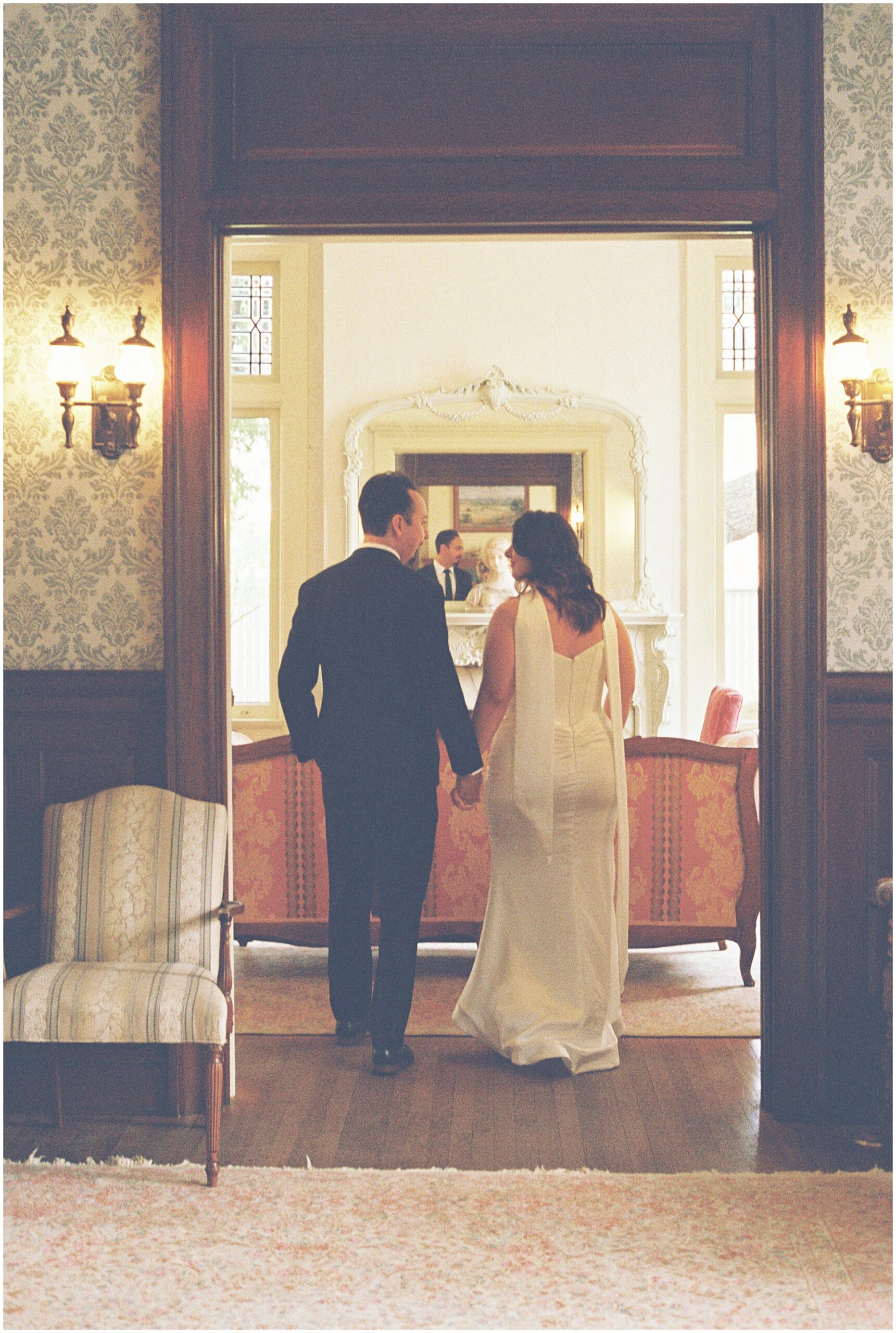 Couple walking through the Alexander Mansion parlor, film