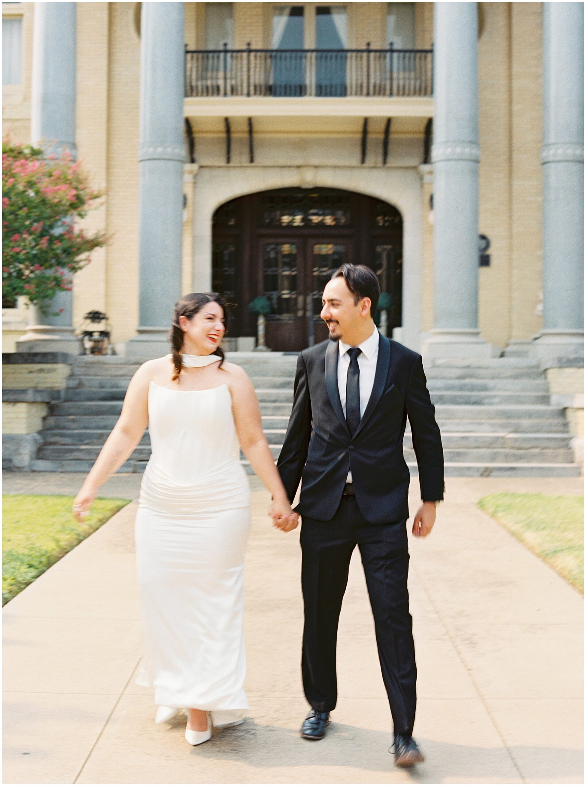 couple walking in front of the Alexander house