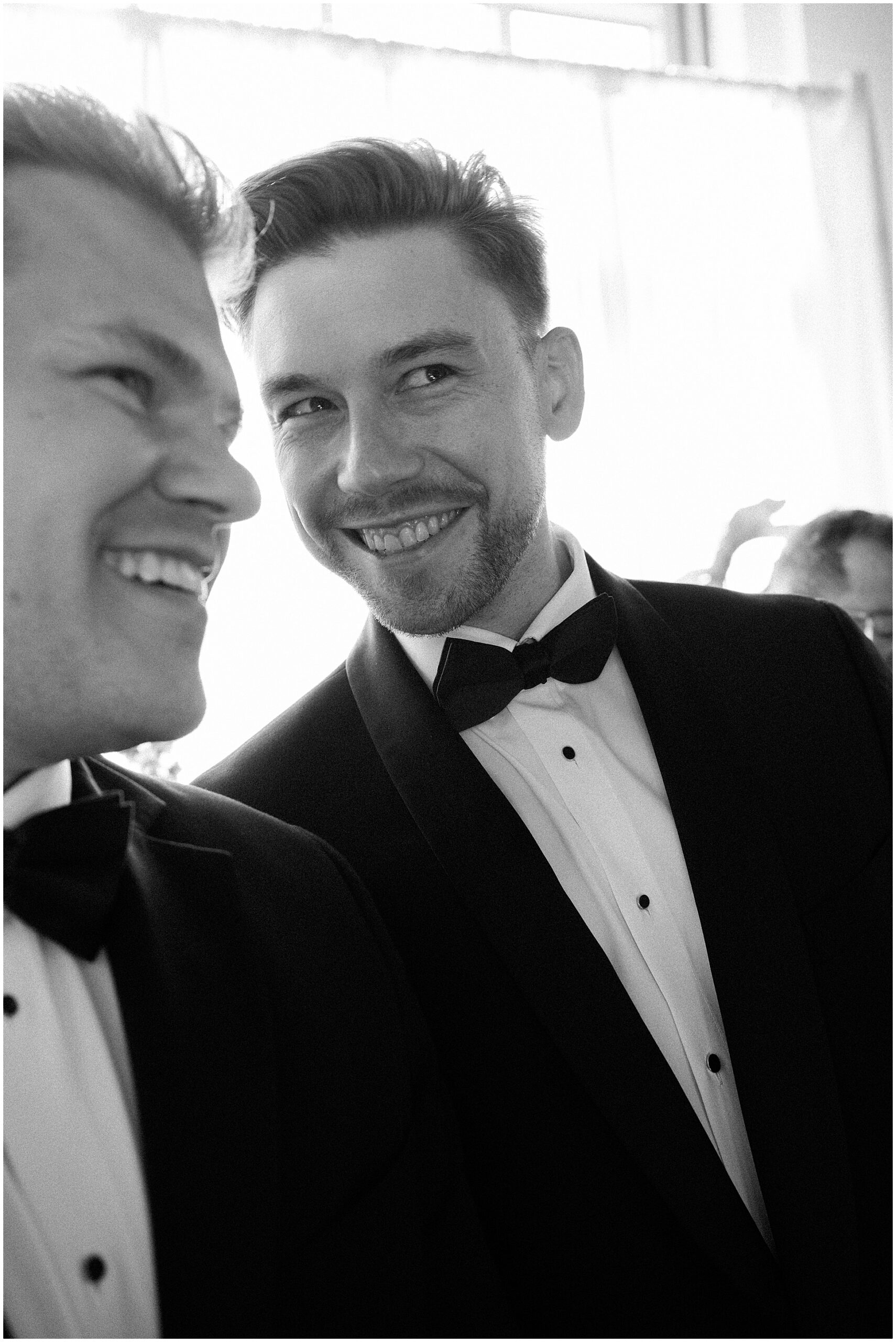groom excited to see his bride walking down the aisle at ceremony