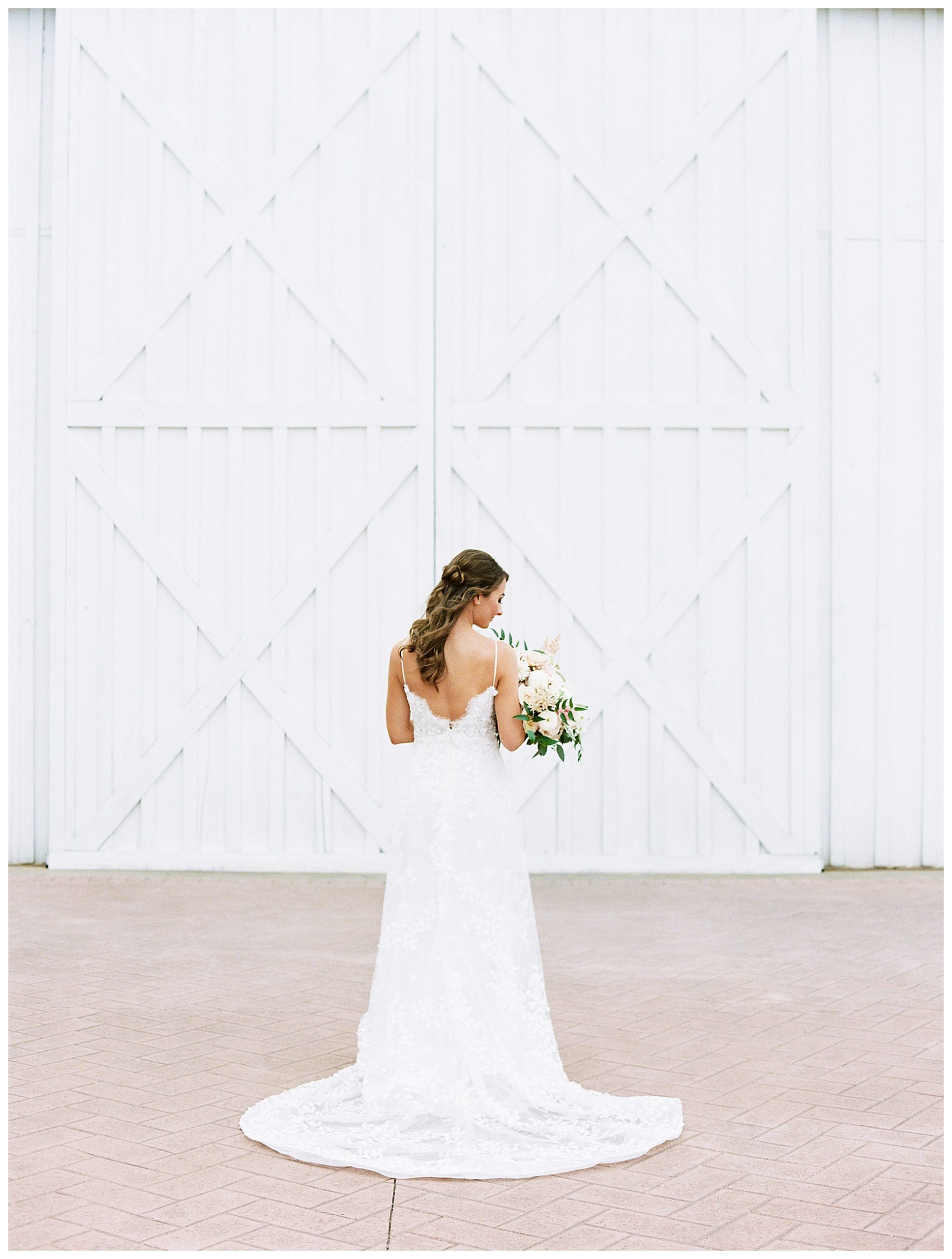 Bride in front of the white sparrow barn