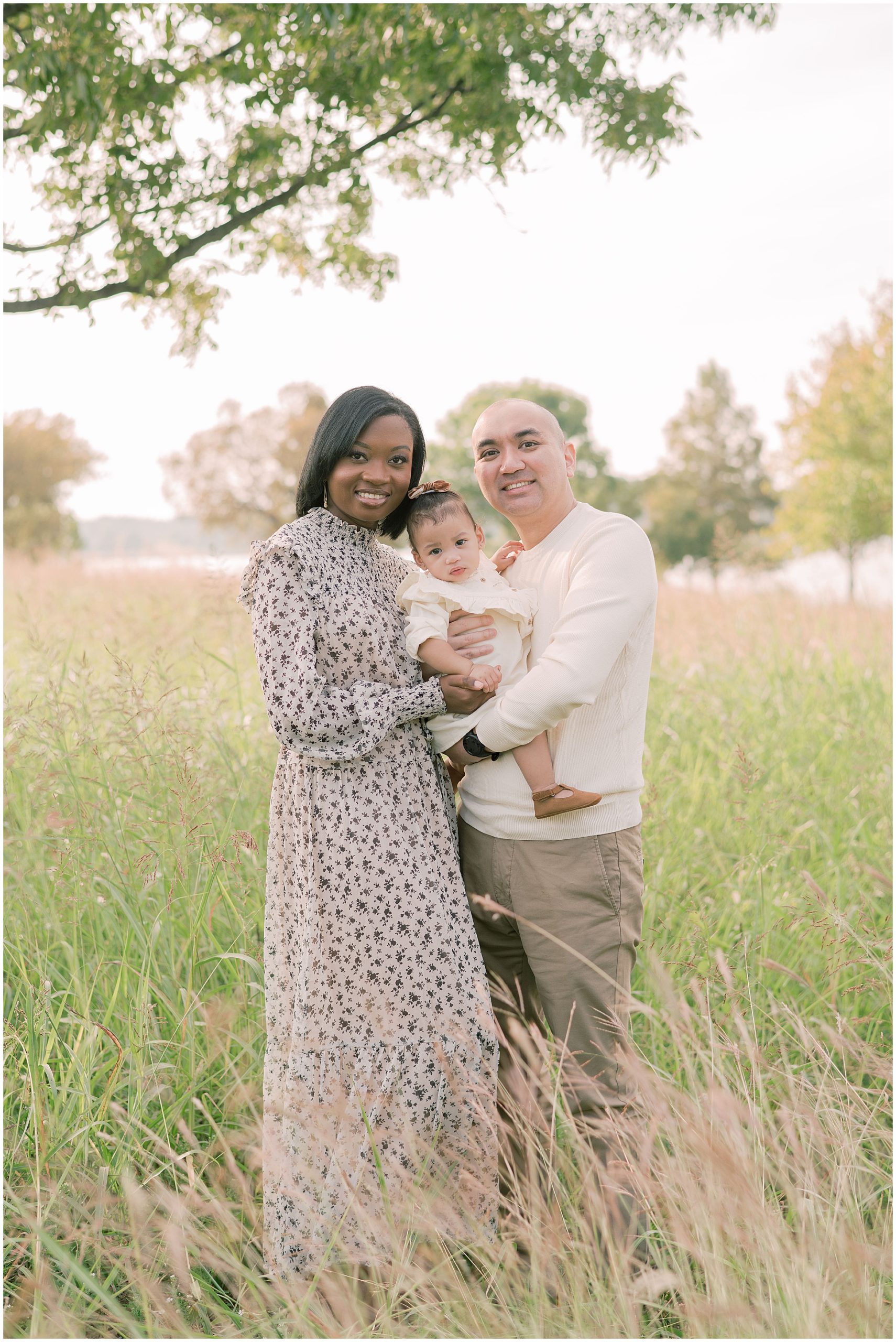 Family enjoying a picturesque session at White Rock Lake in Dallas, Texas surrounded by lush greenery and serene setting 
