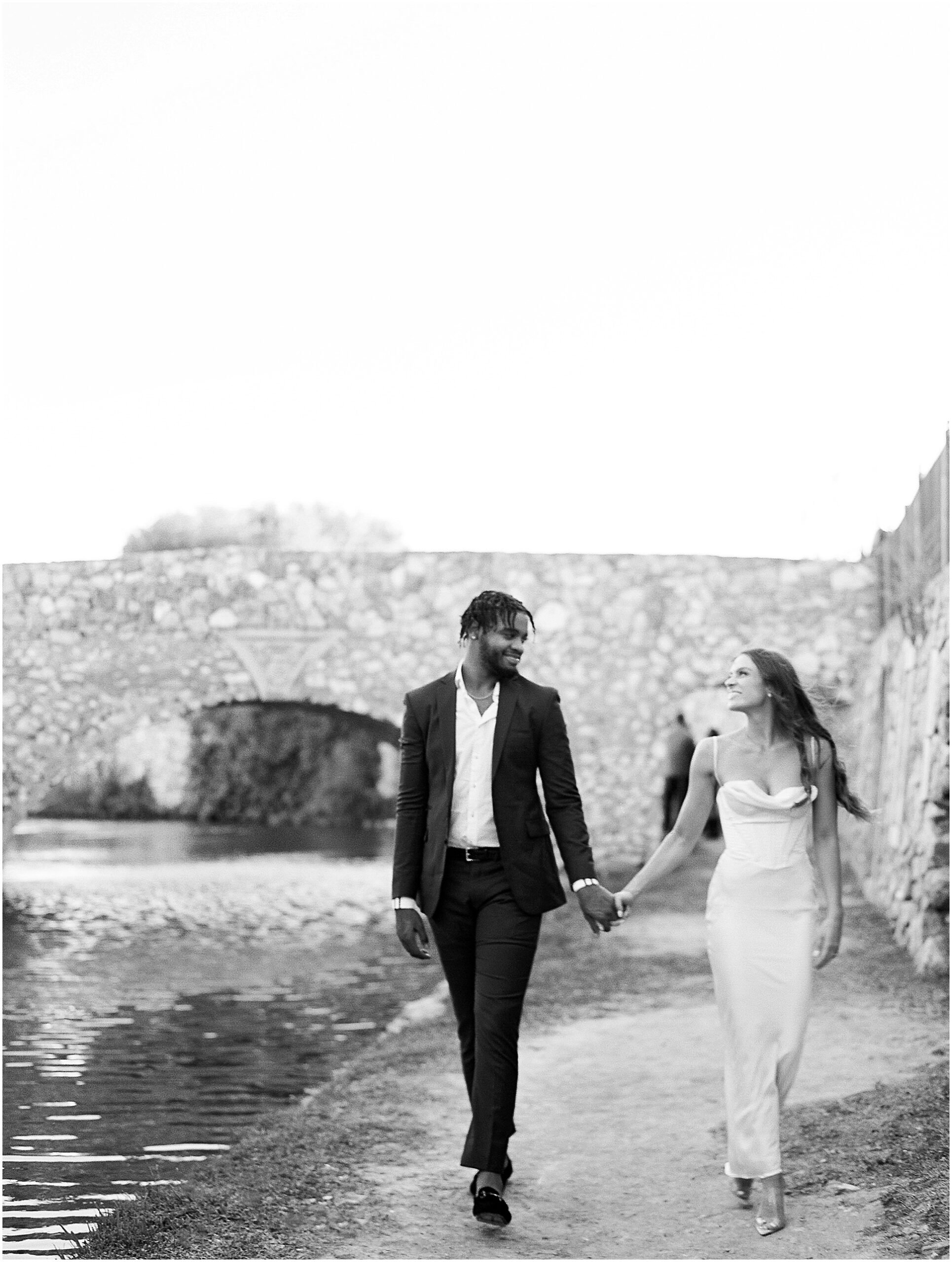 Stylish and Chic couple walking holding hands at adriatica village.