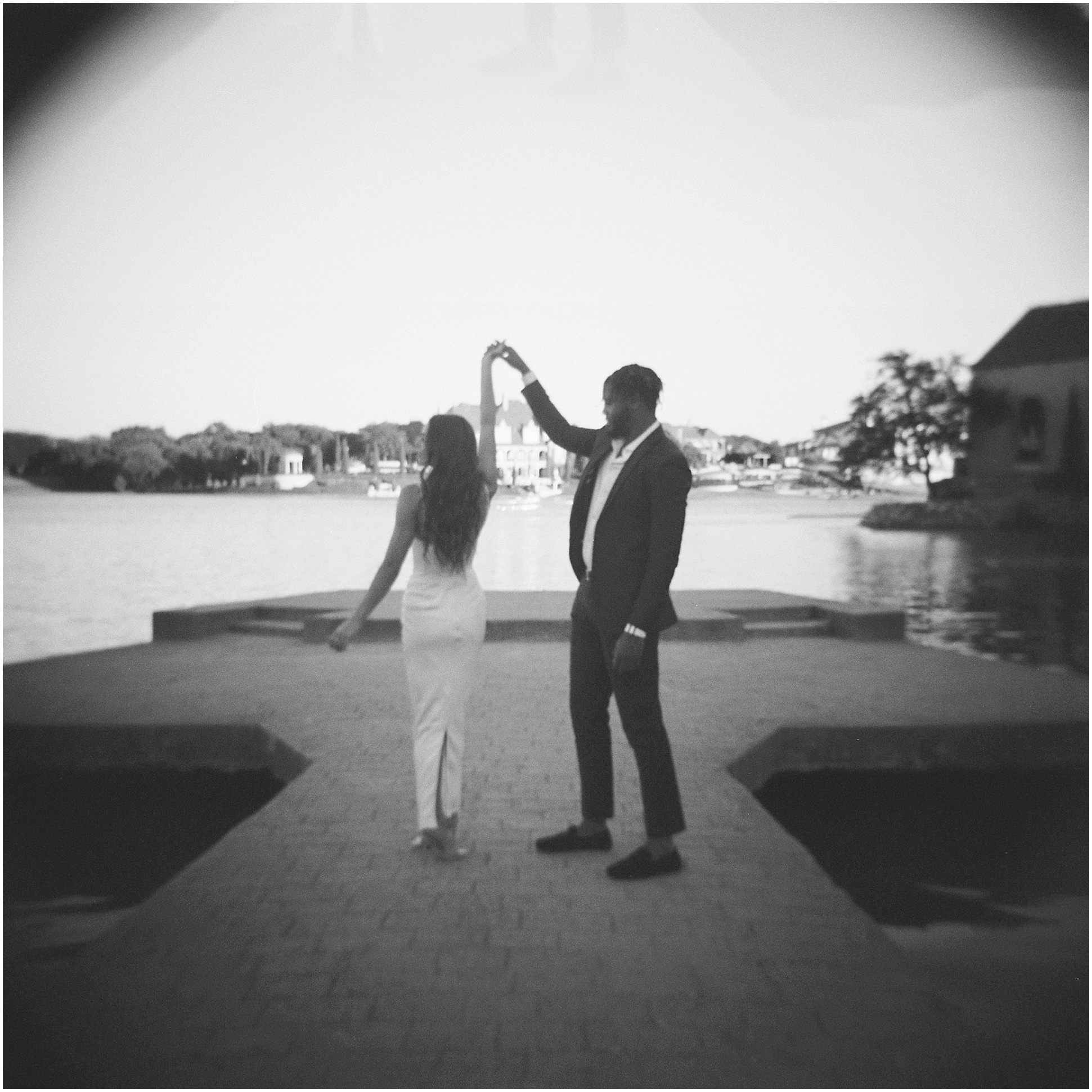 Couple dancing in a romantic pose at adriatica village phot in black and white film image.