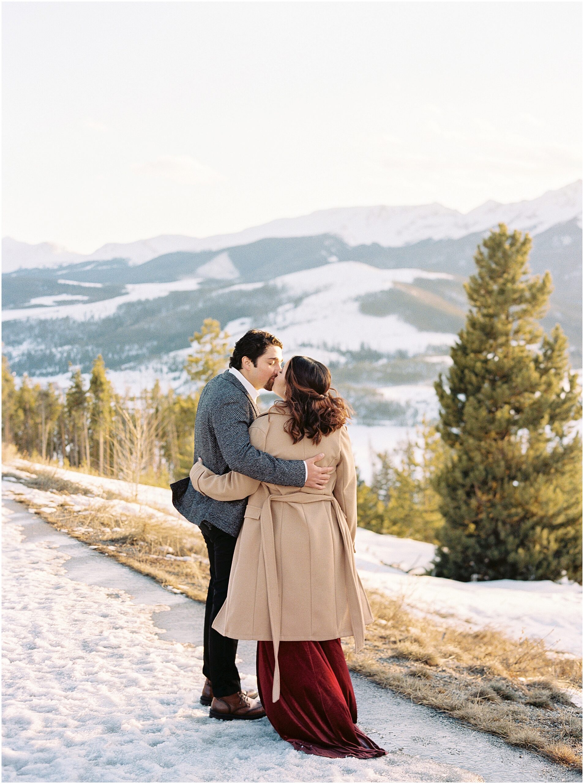 An engaged couple at Sapphire Point, Colorado, overlooking the mountains and Lake Dillon.