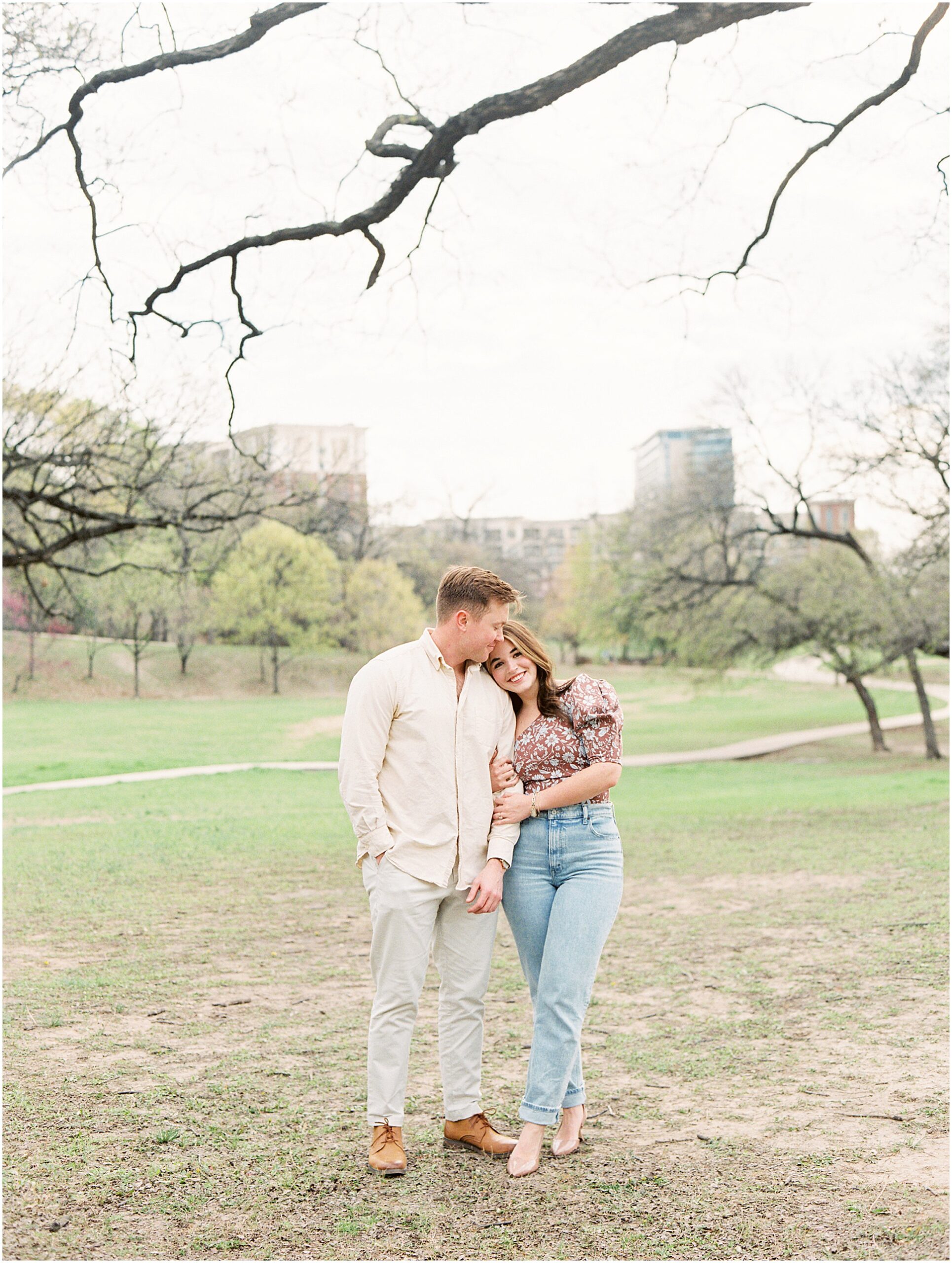 Engaged Couple Catherine and Jack in a sweet embrace in Turtle creek dallas park