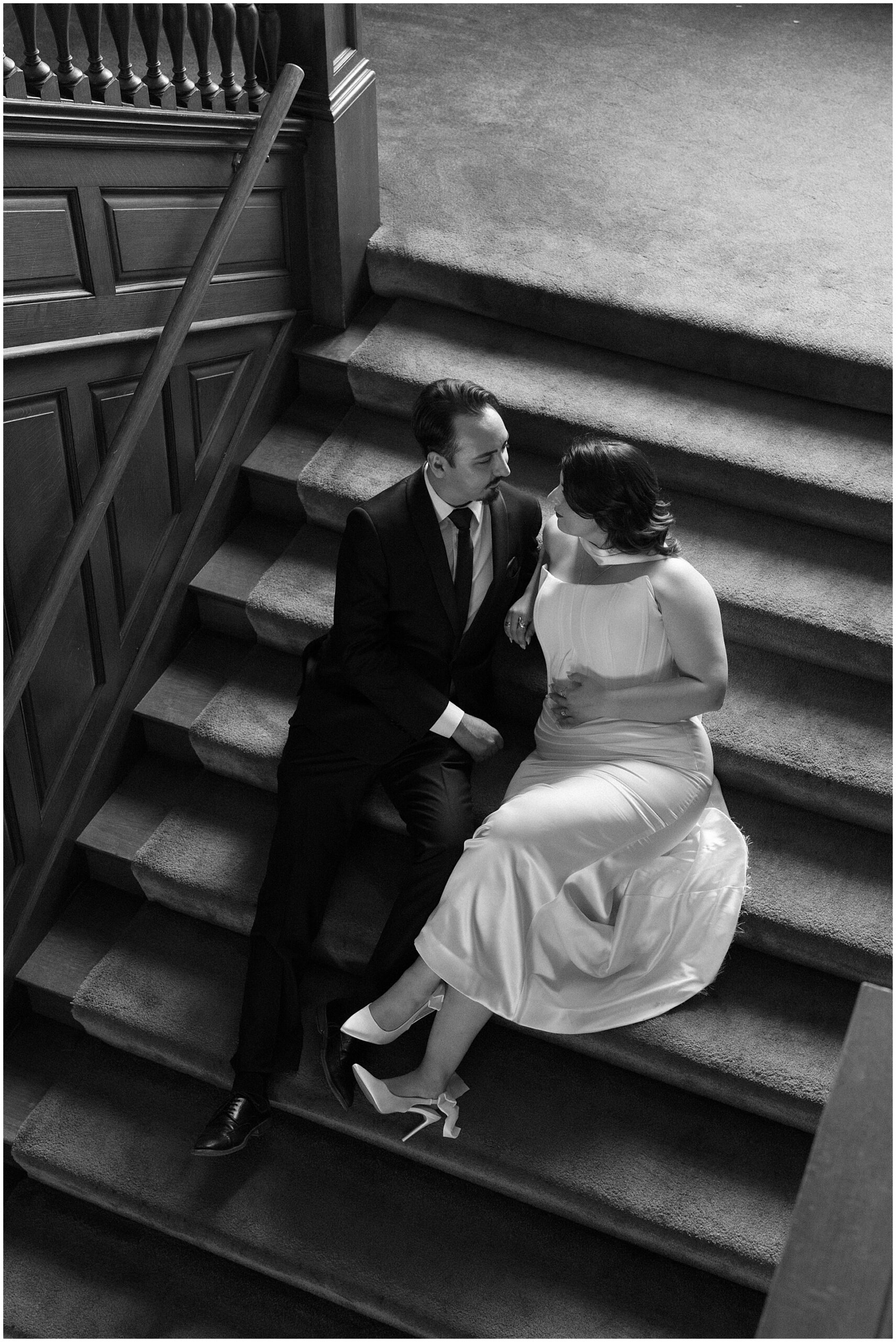 Couple on the grand staircase at the Alexander Mansion Dallas, black and white film